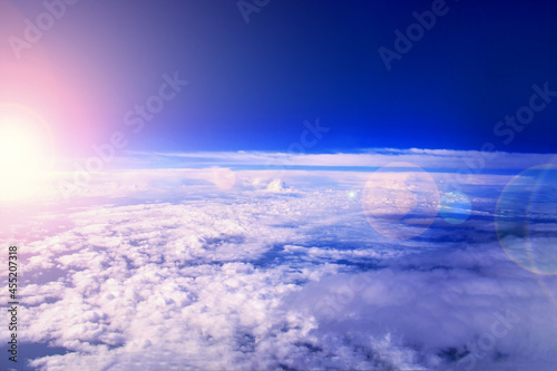 Fototapeta Naklejka Na Ścianę i Meble -  Sunrise in the stratosphere above the clouds. Flying above the clouds in the morning sunlight.