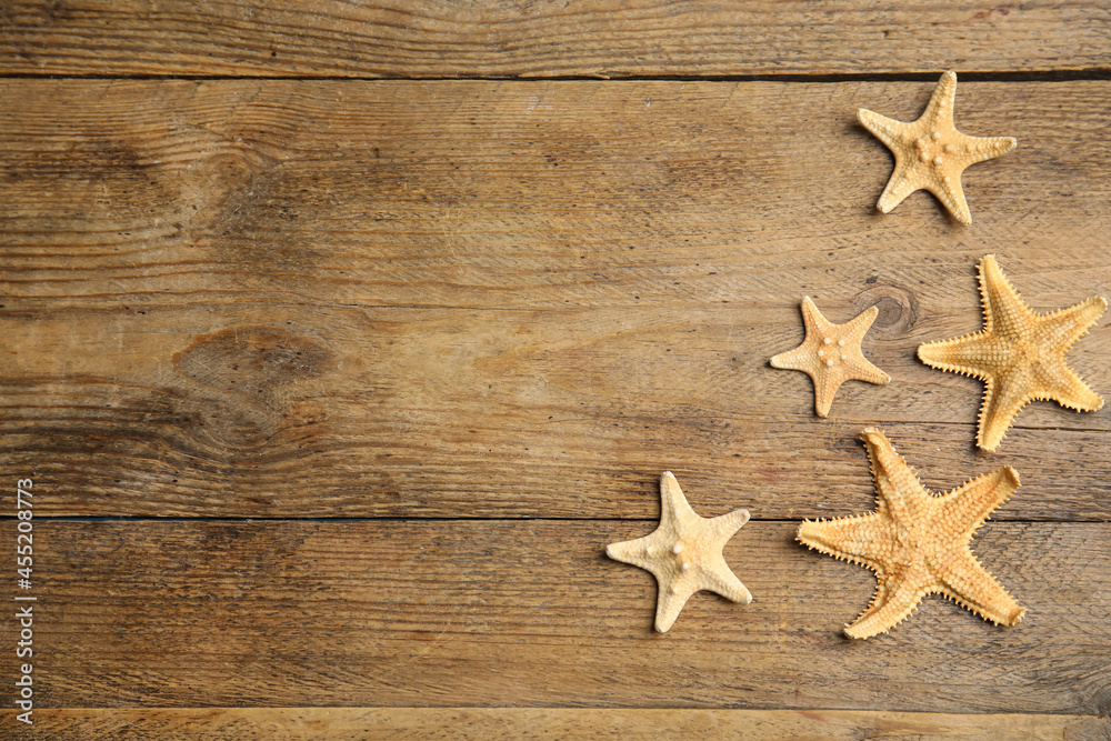 Beautiful sea stars on wooden background, flat lay. Space for text Beautiful sea stars on wooden background, flat lay. Space for text
