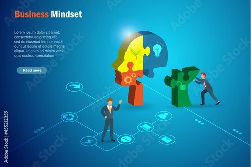 Business unlocked, positive mindset, opening mind and mind set change concept. Businessman connecting jigsaw puzzles missing piece with unlocked key icon in human head.