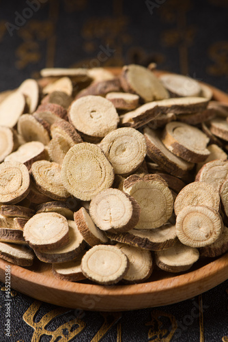 Chinese herbal medicine, sliced of dry Licorice on wooden background