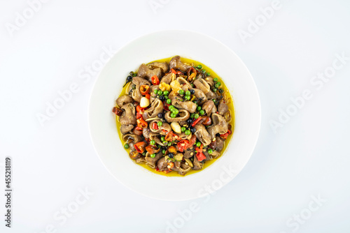 Valokuva Fried large intestine with mountain pepper on a dish on white background