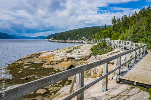 View on the Saguenay Fjord and the Tadoussac, from the rocky shore of the  Pointe de l'Islet hiking trail in Tadoussac, Quebec, Canada photo