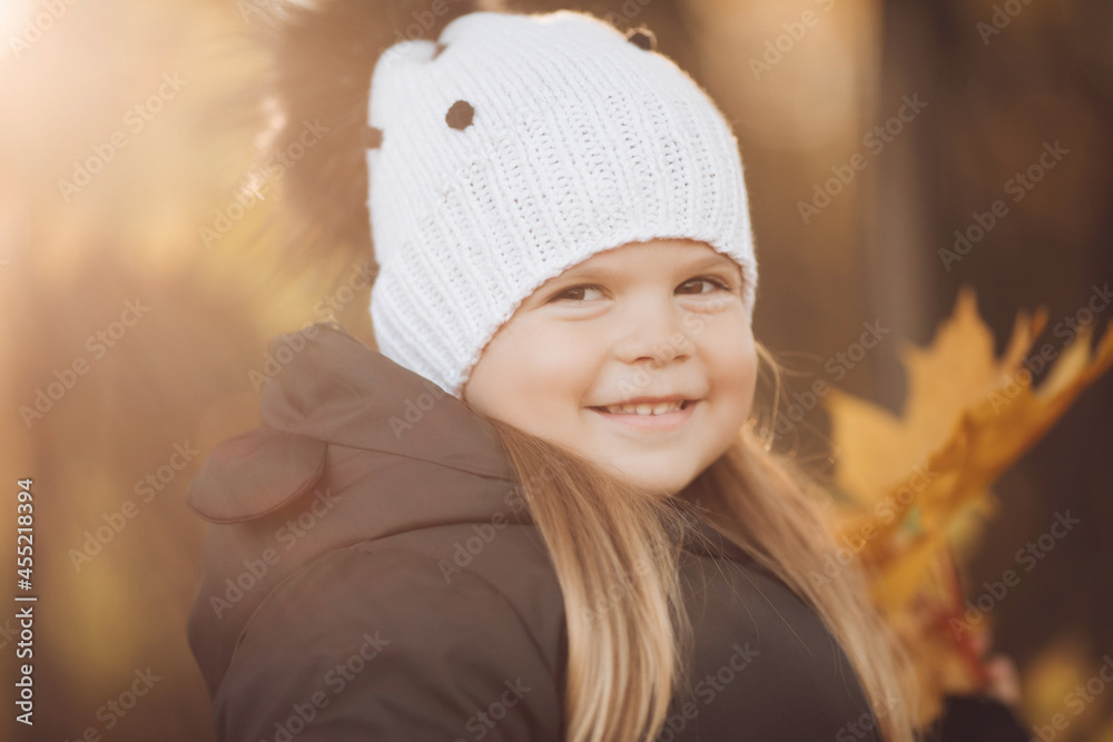 Portrait of beautiful baby goes for a walk in the park in autumn, picture isolated on blur background Portrait of beautiful baby goes for a walk in the park in autumn, picture isolated on blur background