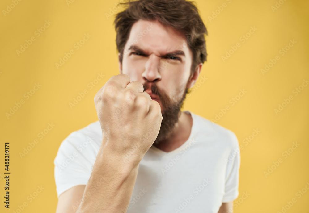 Man in a white t-shirt hand gestures anger Studio Man in a white t-shirt hand gestures anger Studio
