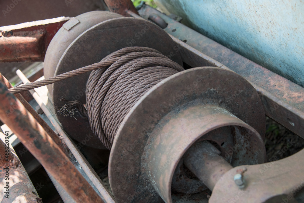 Close-up of a rusty winch with braided steel rope