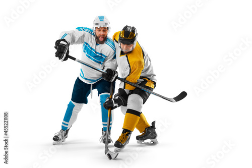 Hockey concept. Two professional hockey players riding on ice. Fight for the puck. Isolated on a white. Sports emotions