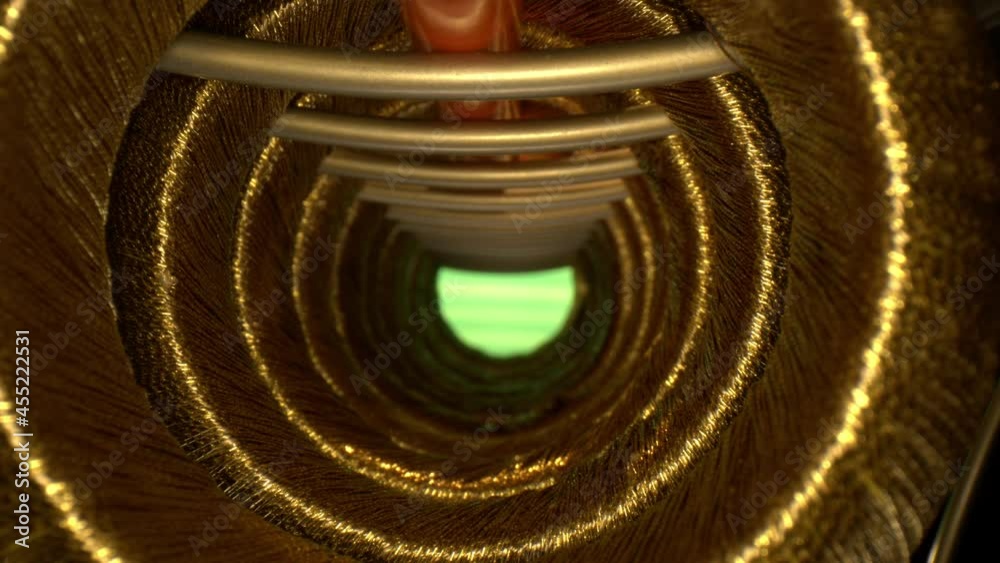 RACK FOCUSING a series of threaded golden rings forming a tunnel that ...