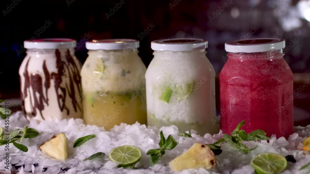 Colourful Frozen Smoothie Jars On Bar. Dolly Forward, Rack Focus Reveal, Track forward Colourful Frozen Smoothie Jars On Bar. Dolly Forward, Rack Focus Reveal, Track forward