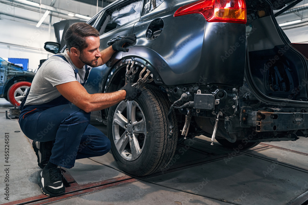Two double clamps placed above car tire during repair
