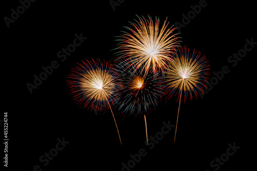 Fireworks of various colors bursting against a black background