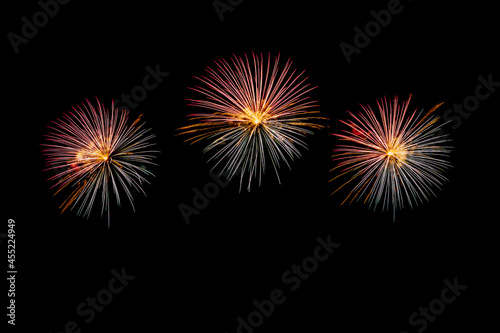 Fireworks of various colors bursting against a black background