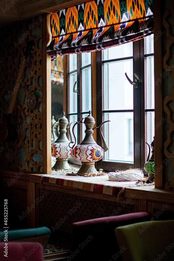 antique pitcher near window in cafe antique pitcher near window in cafe