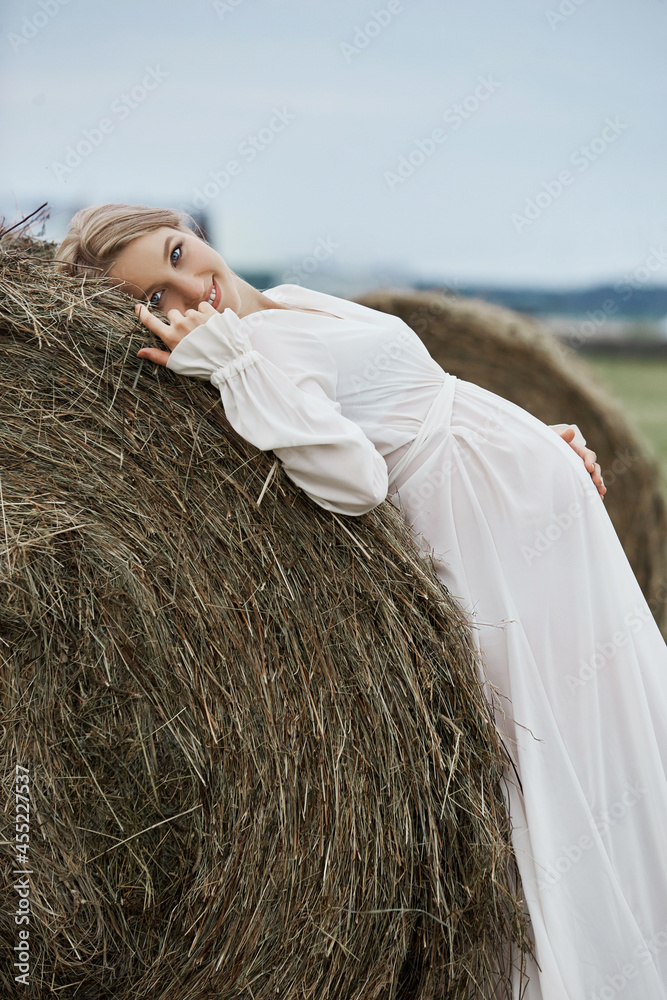 Pregnant woman at 9 months of pregnancy walks in summer in field in village, few days before the birth of the child Pregnant woman at 9 months of pregnancy walks in summer in field in village, few days before the birth of the child