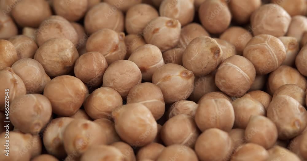 Raw chickpeas, rotation. Chickpeas, close-up dolly shot. Macro footage of chickpeas beans. Food cooking video. Raw chickpeas, rotation. Chickpeas, close-up dolly shot. Macro footage of chickpeas beans. Food cooking video.