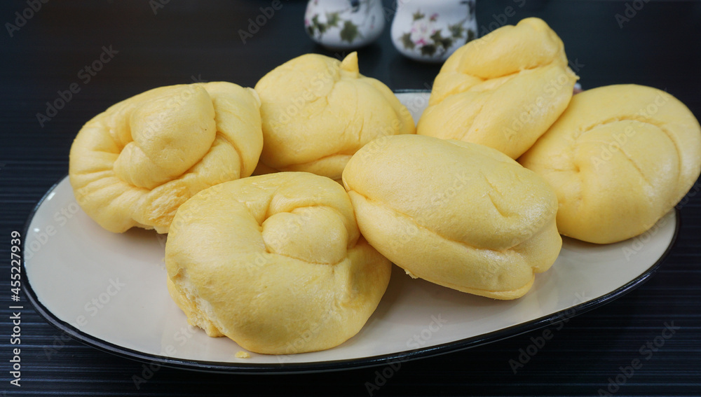 Chinese Hong Kong steamed fresh yellow pumpkin mantou bun vegan green bao in leaf shape on dark grey wood background asian dim sum halal food restaurant cuisine banquet menu for cafe Chinese Hong Kong steamed fresh yellow pumpkin mantou bun vegan green bao in leaf shape on dark grey wood background asian dim sum halal food restaurant cuisine banquet menu for cafe