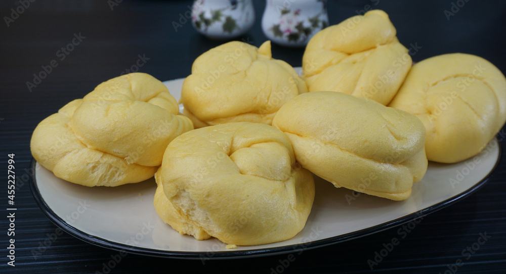 Chinese Hong Kong steamed fresh yellow pumpkin mantou bun vegan green bao in leaf shape on dark grey wood background asian dim sum halal food restaurant cuisine banquet menu for cafe Chinese Hong Kong steamed fresh yellow pumpkin mantou bun vegan green bao in leaf shape on dark grey wood background asian dim sum halal food restaurant cuisine banquet menu for cafe