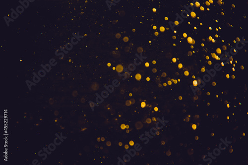 Golden bokeh of lights on black background