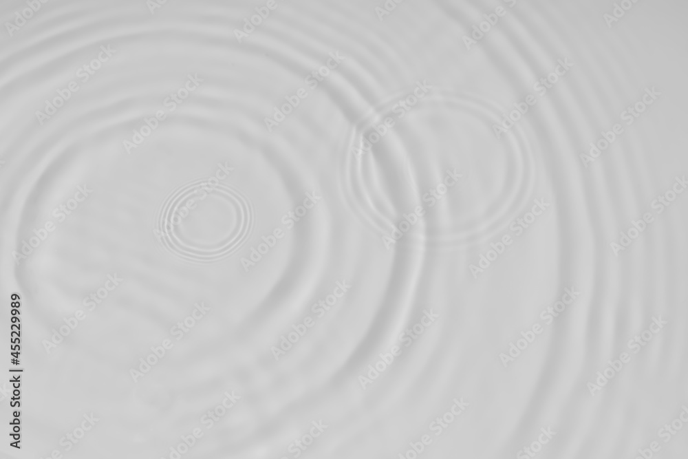 Water tranquil ripple background. Water texture, circles and bubbles on a liquid white surface. Cosmetic products and flat design concept Water tranquil ripple background. Water texture, circles and bubbles on a liquid white surface. Cosmetic products and flat design concept