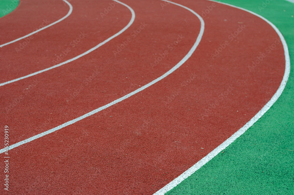 Empty running tracks. Red jogging tracks at the stadium. Sports, active lifestyle. Selective focus. Empty running tracks. Red jogging tracks at the stadium. Sports, active lifestyle. Selective focus.