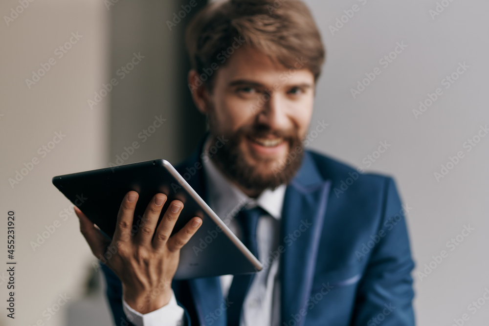 Cheerful business man tablet in hands communicating work Cheerful business man tablet in hands communicating work