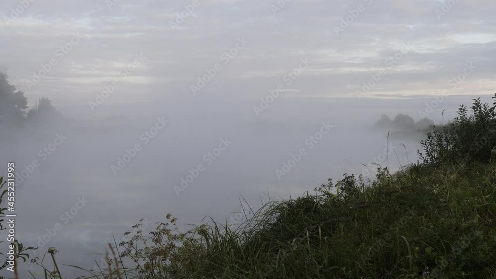 morning fog spreads over the smooth water of the river morning fog spreads over the smooth water of the river