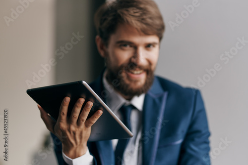 Cheerful business man tablet in hands communicating work