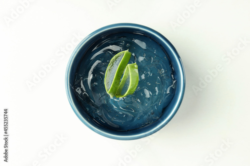 Bowl with aloe gel and slices on white background