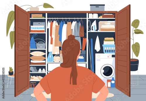 Woman standing in front of tidy wardrobe after decluttering. Back of person looking at open closet with arranged clothes storing. Storage organization and order in cupboard. Flat vector illustration