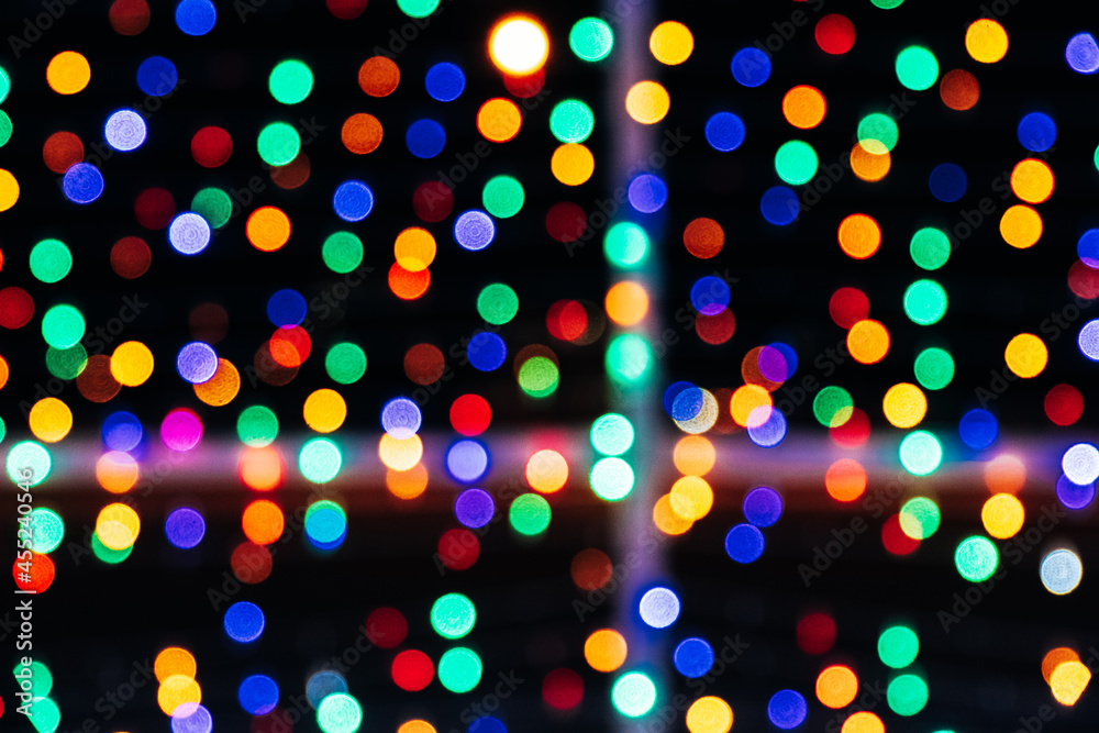 Texture of blurred colored lights on a black background Texture of blurred colored lights on a black background
