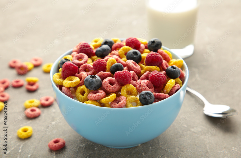 Breakfast with cereals, milk and berry on grey background. Breakfast with cereals, milk and berry on grey background.