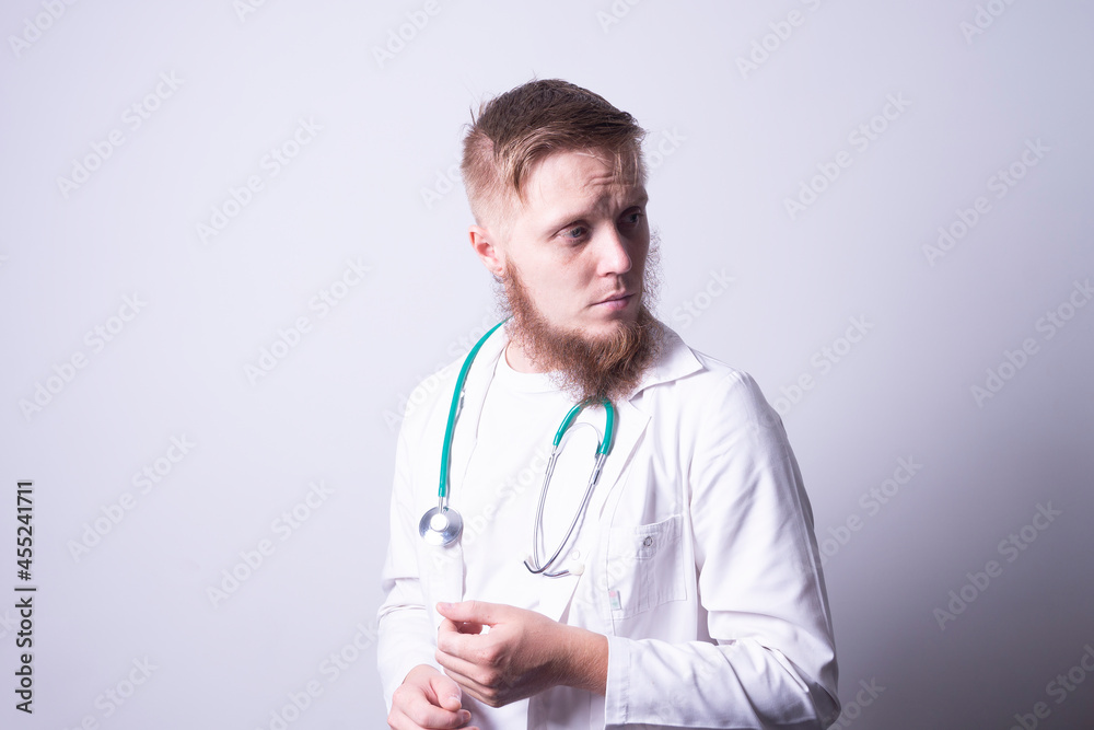 Male doctor in laboratory coat on gray background