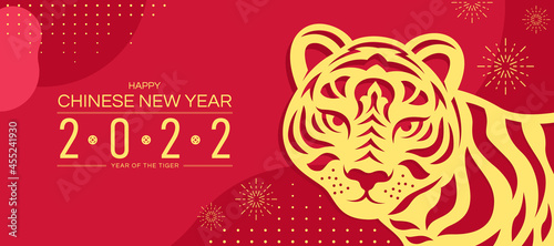 Happy chinese new year 2022 year of the tiger banner with gold abstract paper cut tiger zodiac sign on red texture with dot and firework background vector design