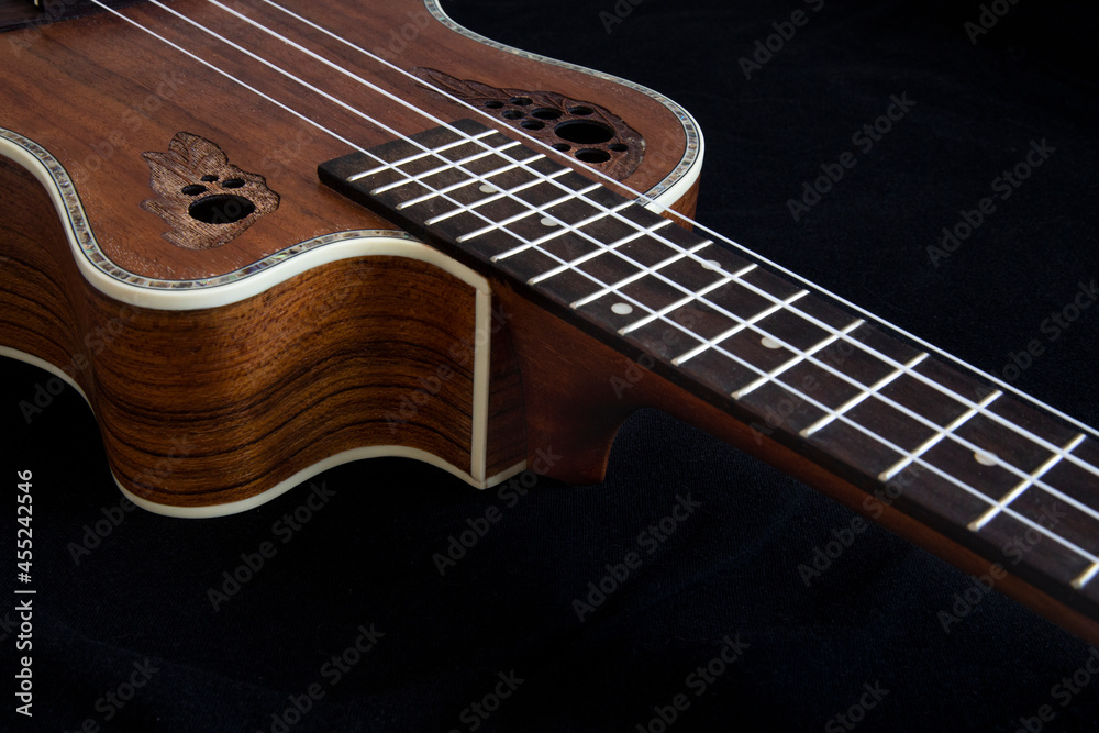 Ukulele with carved leaf ornaments Ukulele with carved leaf ornaments