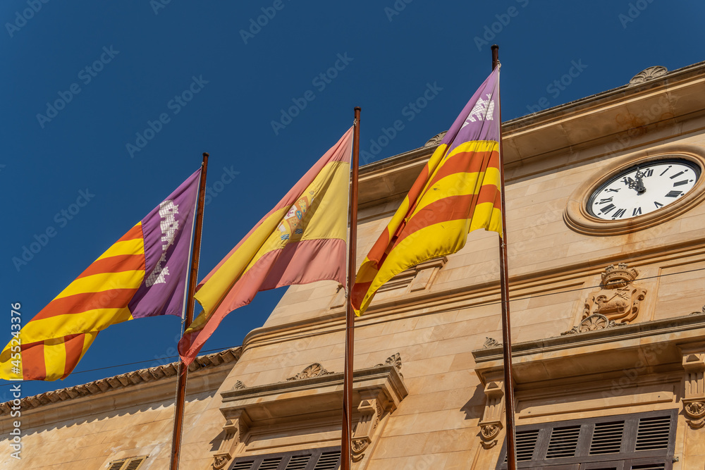 Main facade of Santanyi Town Hall with the flags of Spain, the Balearic Islands and Mallorca. Island of Mallorca, Spain