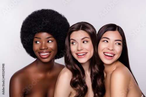 Photo of three young attractive girls happy positive smile laugh salon procedure hydration isolated over grey color background