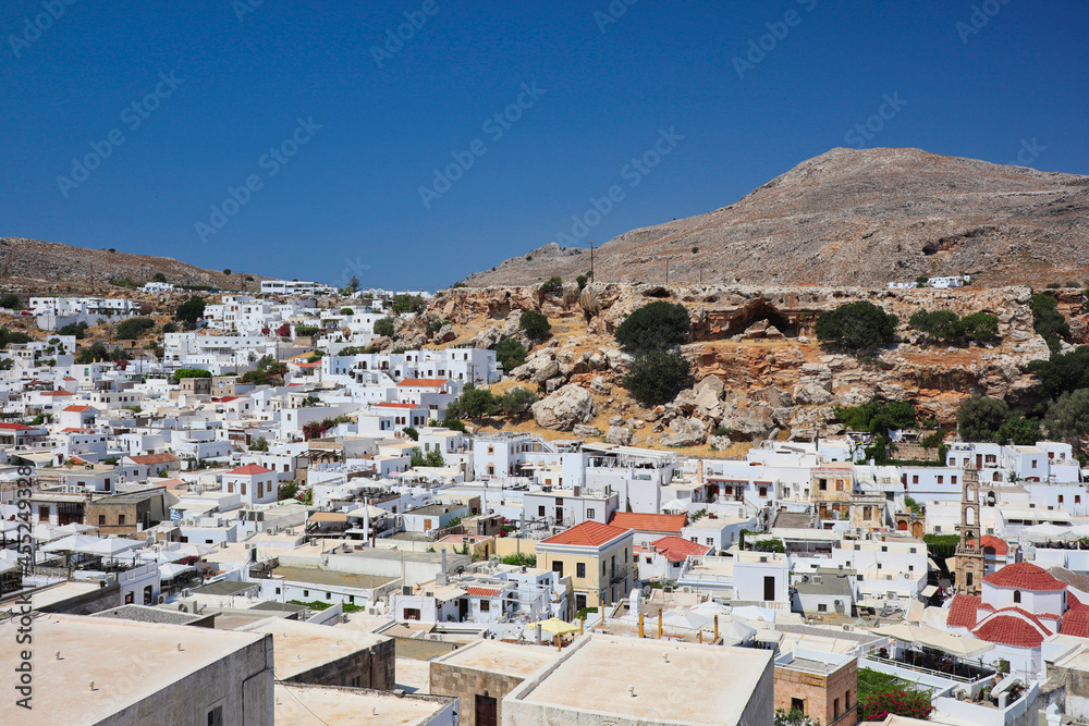 Beautiful Greek White Village with Hill and Blue Sky. Urban View of Lindos in Rhodes during Day.