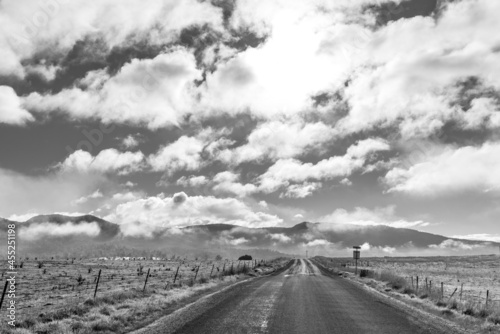 A road leading towards the mountains in the Tasmanian countryside