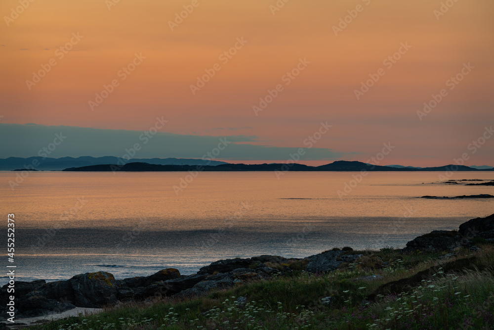 Sunset on the Mull of kintyre looking at the Isle of Islay in Argyll and Bute, Scotland