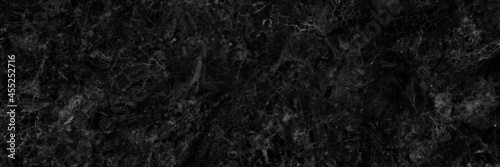 black marble texture with white veins.