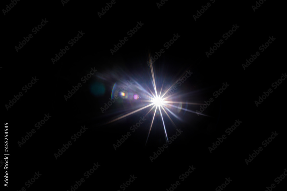Easy to add lens flare effects for overlay designs or screen blending mode to make high-quality images. Abstract sun burst, digital flare, iridescent glare over black background.