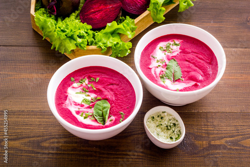 Homemade summer beet soup with raw beet roots and green leaves