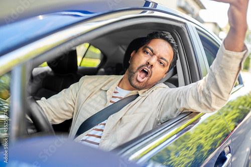 Fotografie transport, vehicle and people concept - angry indian man or driver driving car a