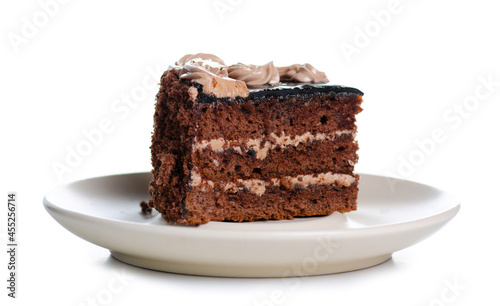 Piece of chocolate cake on plate on white background isolation