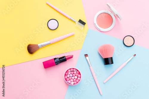 Makeup products and decorative cosmetics on color background flat lay. Fashion and beauty blogging concept