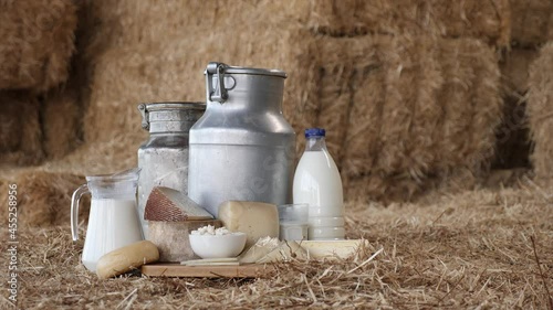 Composition of dairy products: milk, cheese, yoghurt and cream on hay bales photo