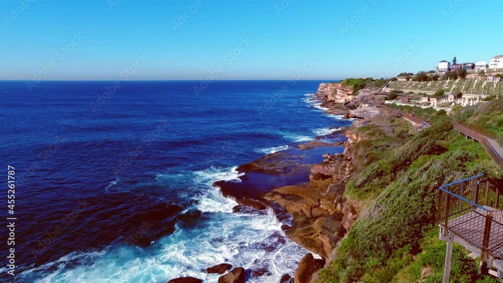 Waves crashing on the rocks below the Bondi to Bronte Coastal Walk with views of Waverley Cemetery. Waves crashing on the rocks below the Bondi to Bronte Coastal Walk with views of Waverley Cemetery.