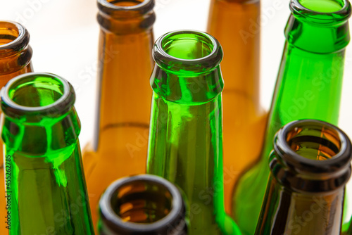 Necks of empty bottles, photographed closely. Use and reuse of glass. Waste and recycling.