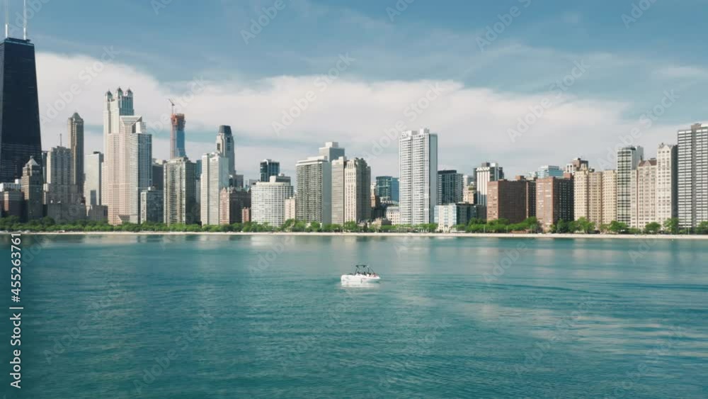 Aerial view of Chicago skyline and white sailing boat in Michigan lake blue green still waters with downtown Chicago on motion background. Water sports tourism, leisure activity, summer vacation 4K Aerial view of Chicago skyline and white sailing boat in Michigan lake blue green still waters with downtown Chicago on motion background. Water sports tourism, leisure activity, summer vacation 4K