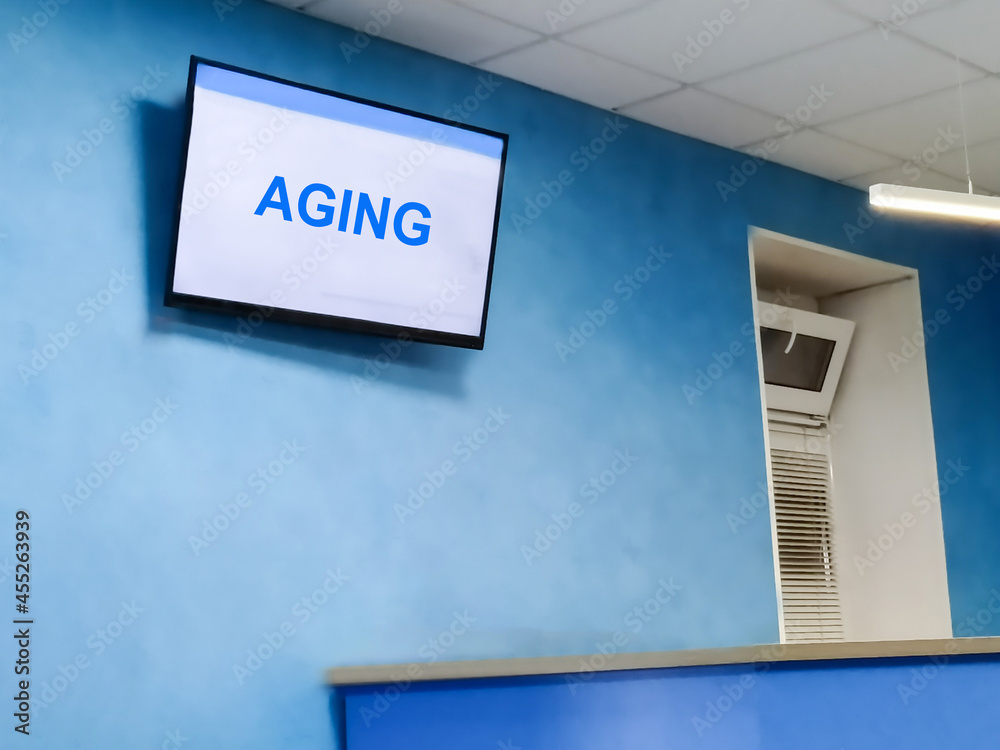 Aging is the word on the TV screen in the hospital. Aging and medicine concept