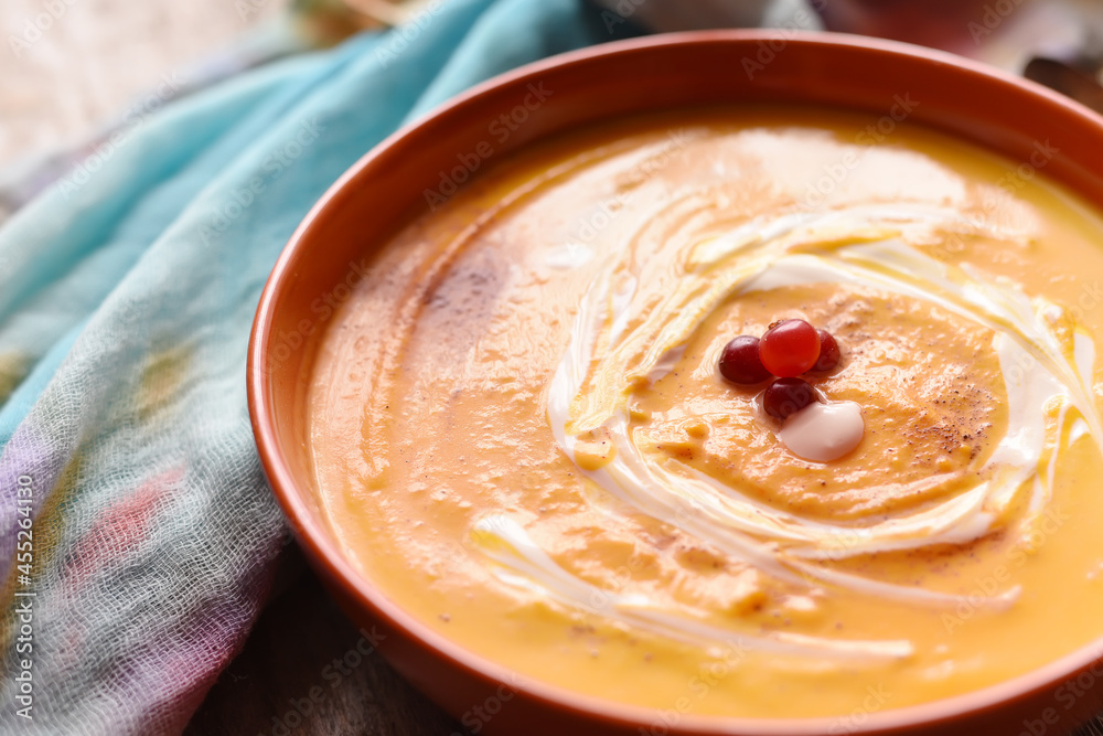 Autumn pumpkin soup on a rough wooden table. Autumn pumpkin soup on a rough wooden table.